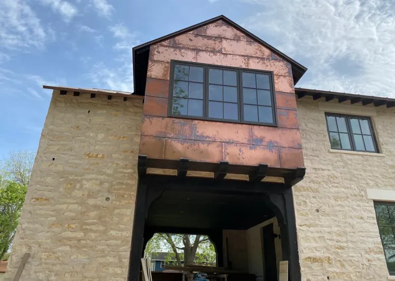 Copper metal panel facade on a stone building for Metal Roof Coating in Arvada